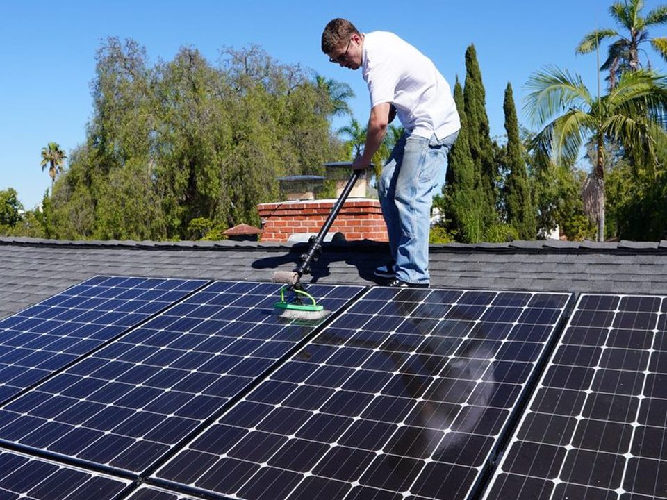 ORCA cleaning a rooftop solar panel array